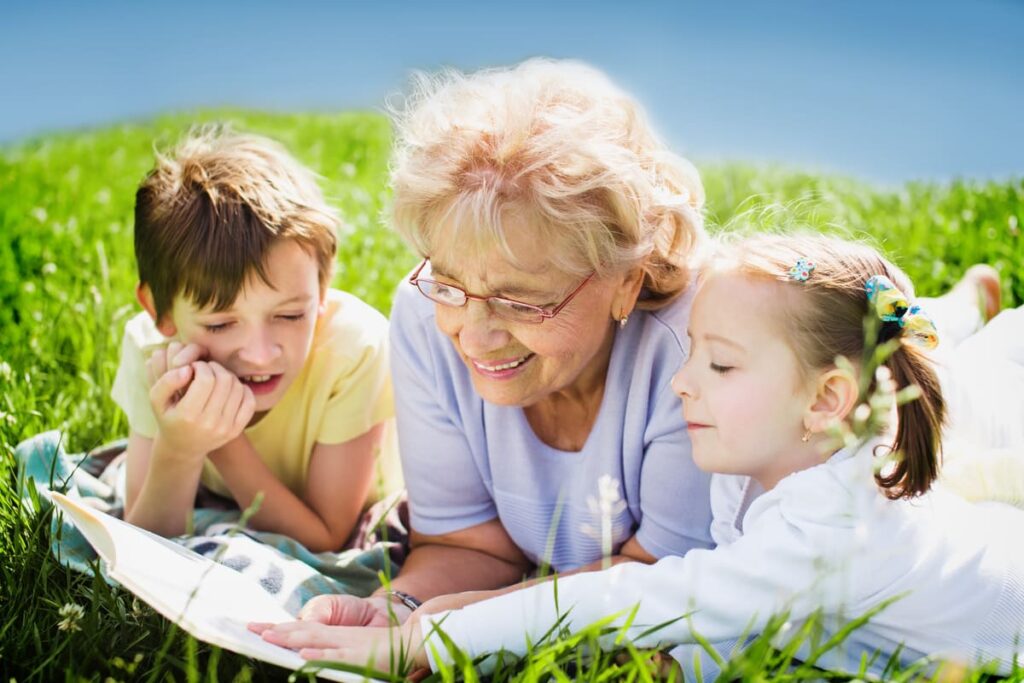 The Lodge at Stephens Lake | Grandmother reading to grandchildren