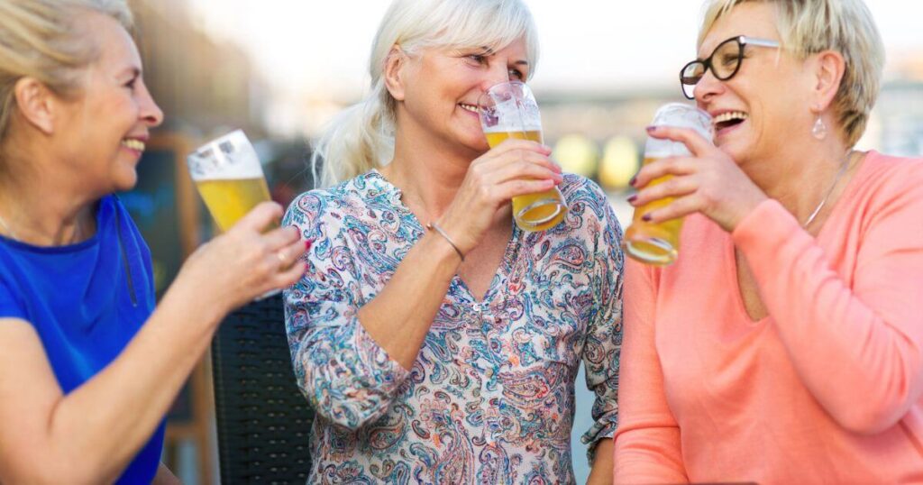 A group of three senior women cheersing their glasses at an independent living community.