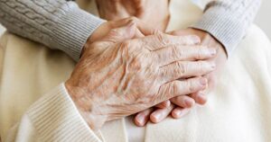 The Lodge at Stephens Lake | senior woman holding a caregiver's hands