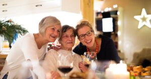 The Lodge at Stephens Lake | two senior women and a younger woman celebrating in a kitchen